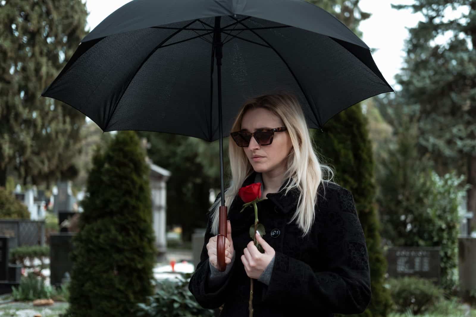 A woman in black mourns the loss of a loved one due to a wrongful death in Portland, ME.