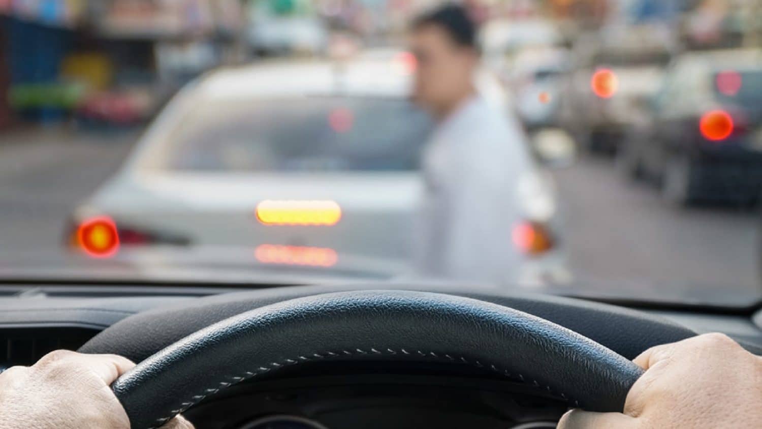 Car Approaching Pedestrian Crossing The Street Stock Photo