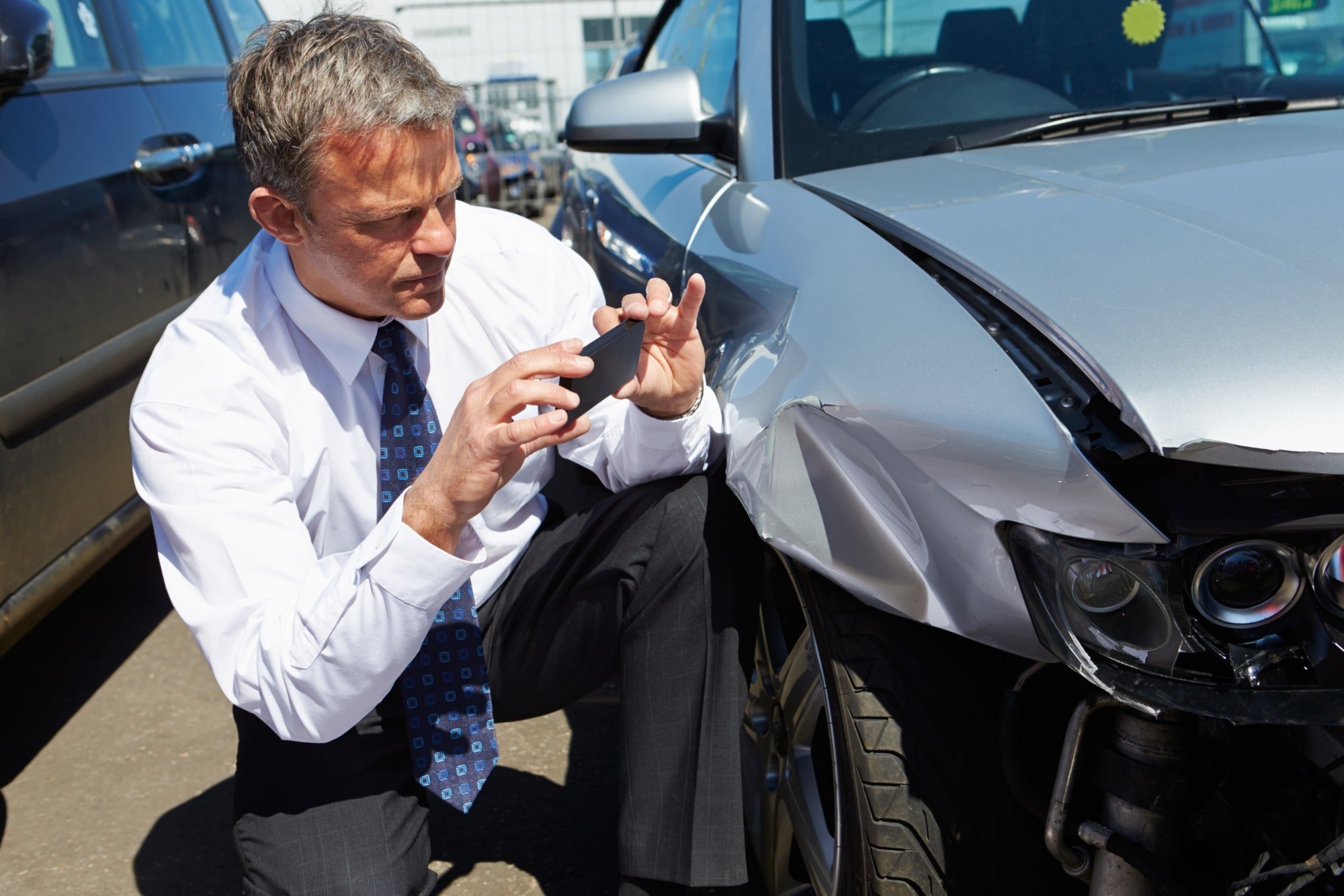 insurance adjuster documenting damage after a car accident