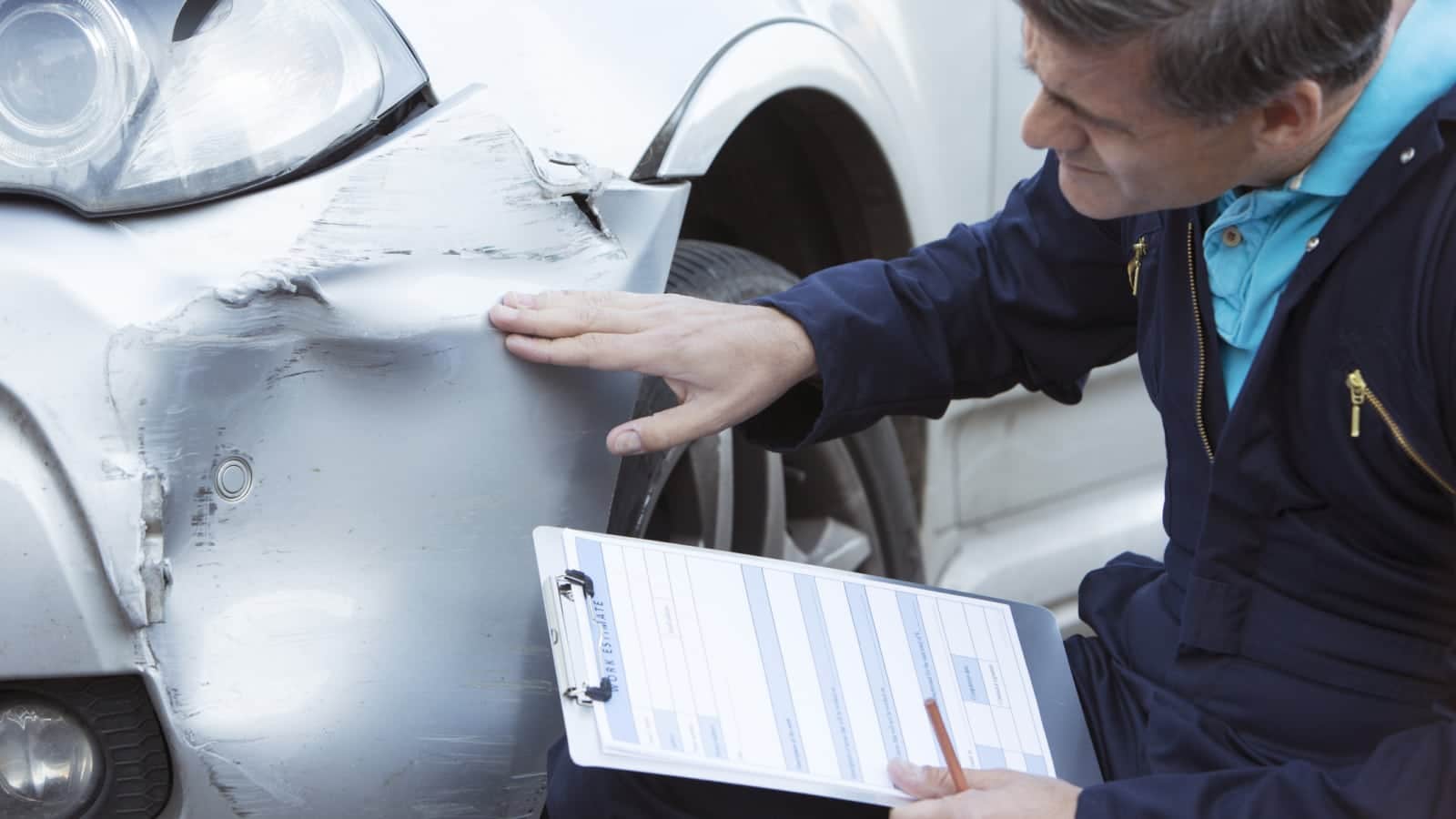 Mechanic Examining Car Stock Photo