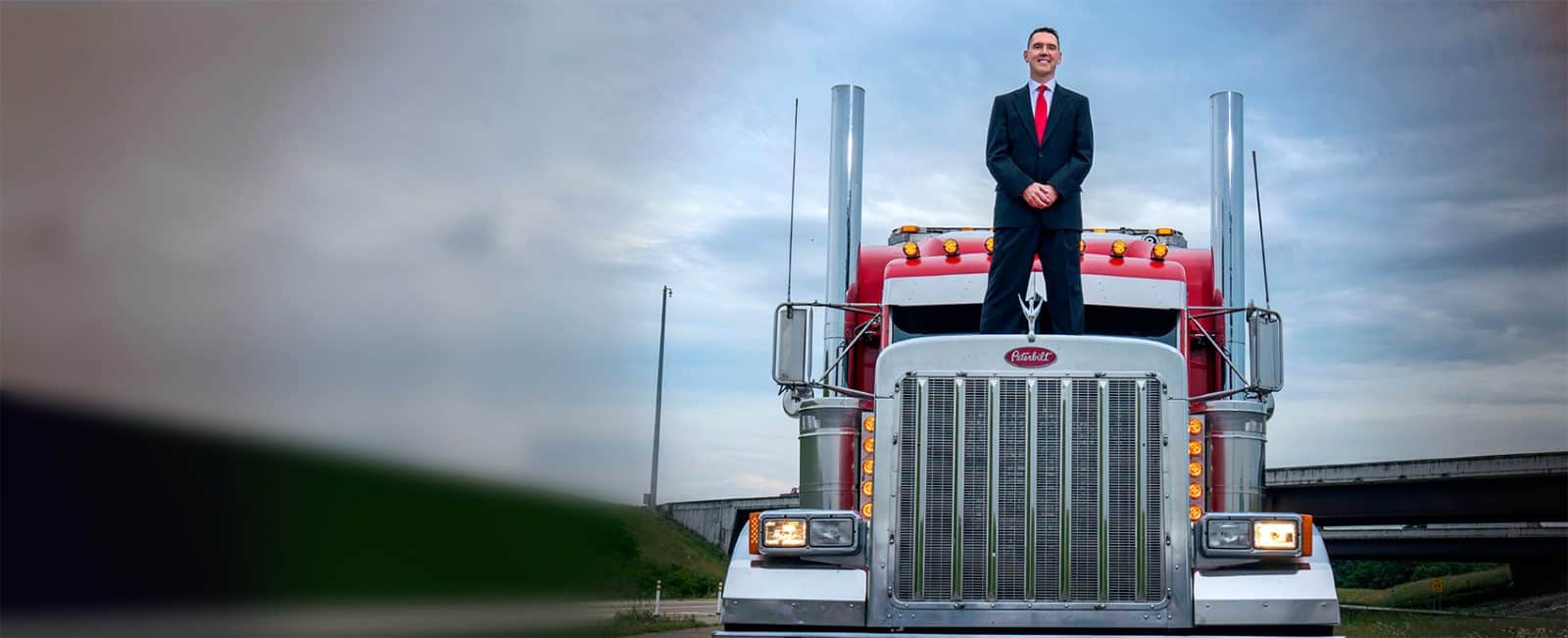 Attorney James Beardsley standing on top of big truck